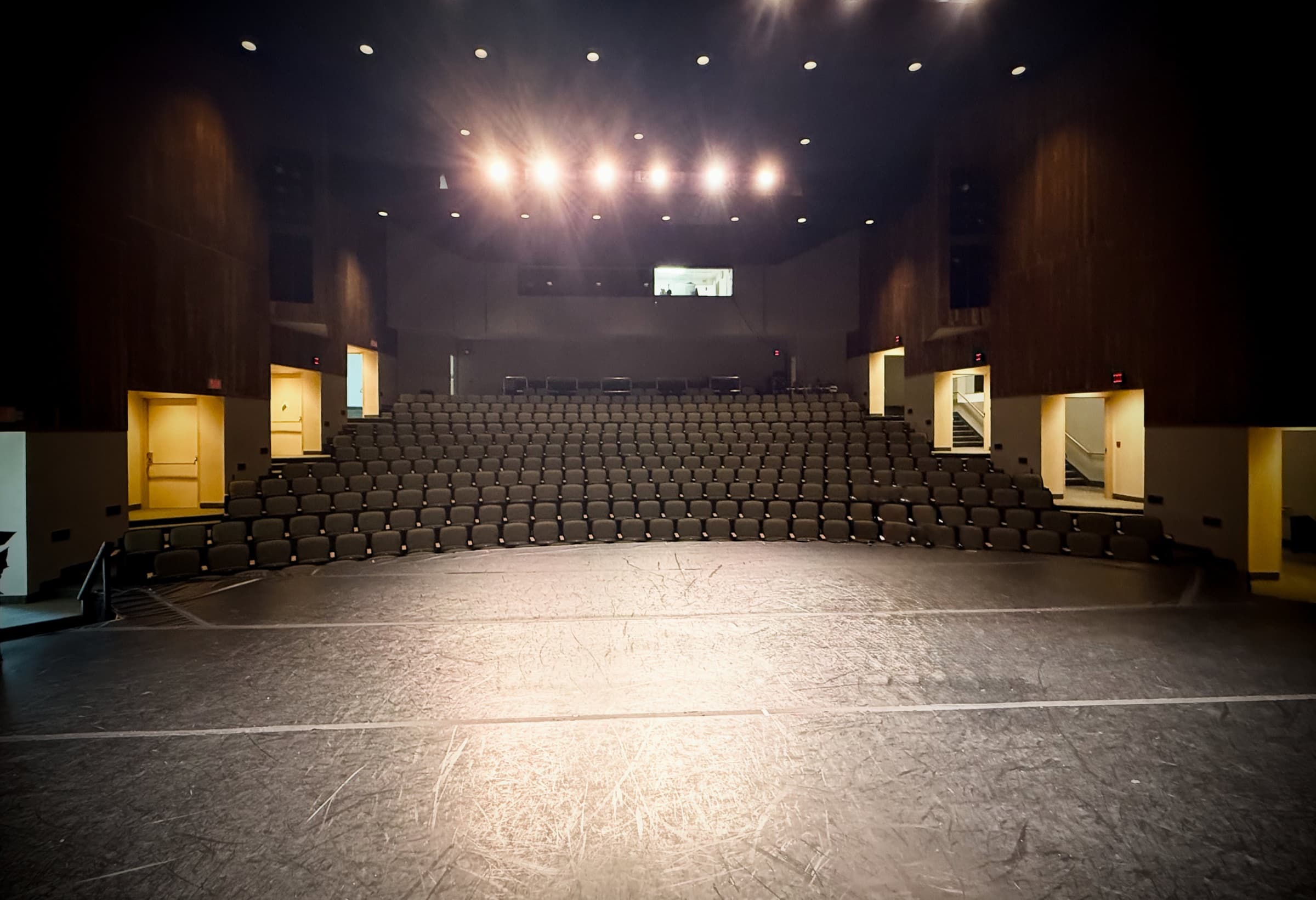 Maguire Theatre at SUNY Old Westbury auditorium seen from the stage — empty seating bowl, intimate sightlines for the DXNY recital