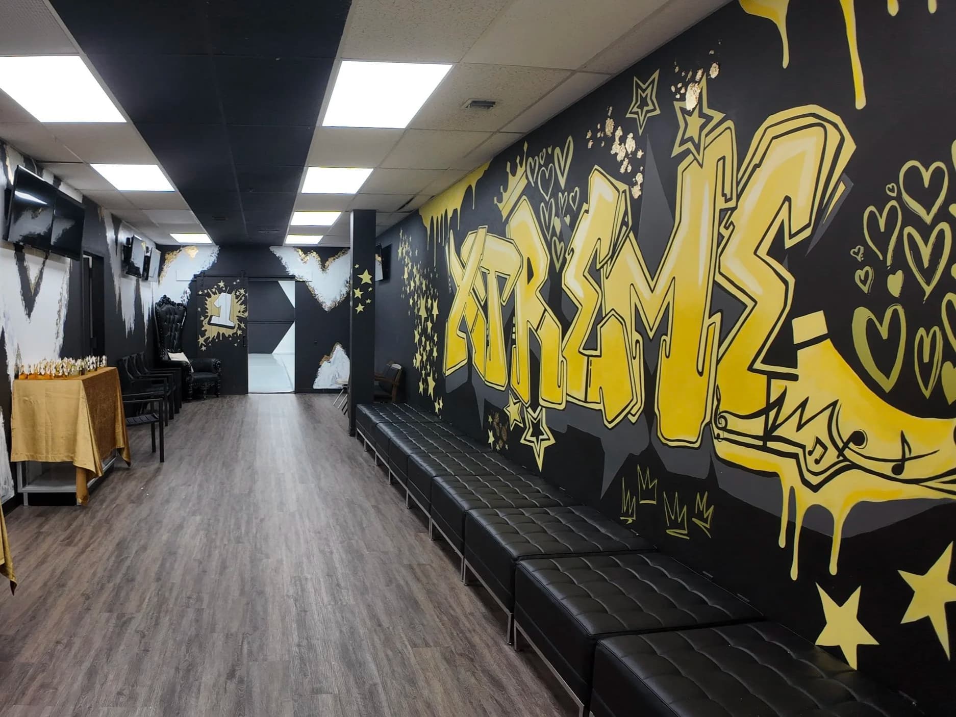DXNY hallway with graffiti mural, bench seating, and trophy displays