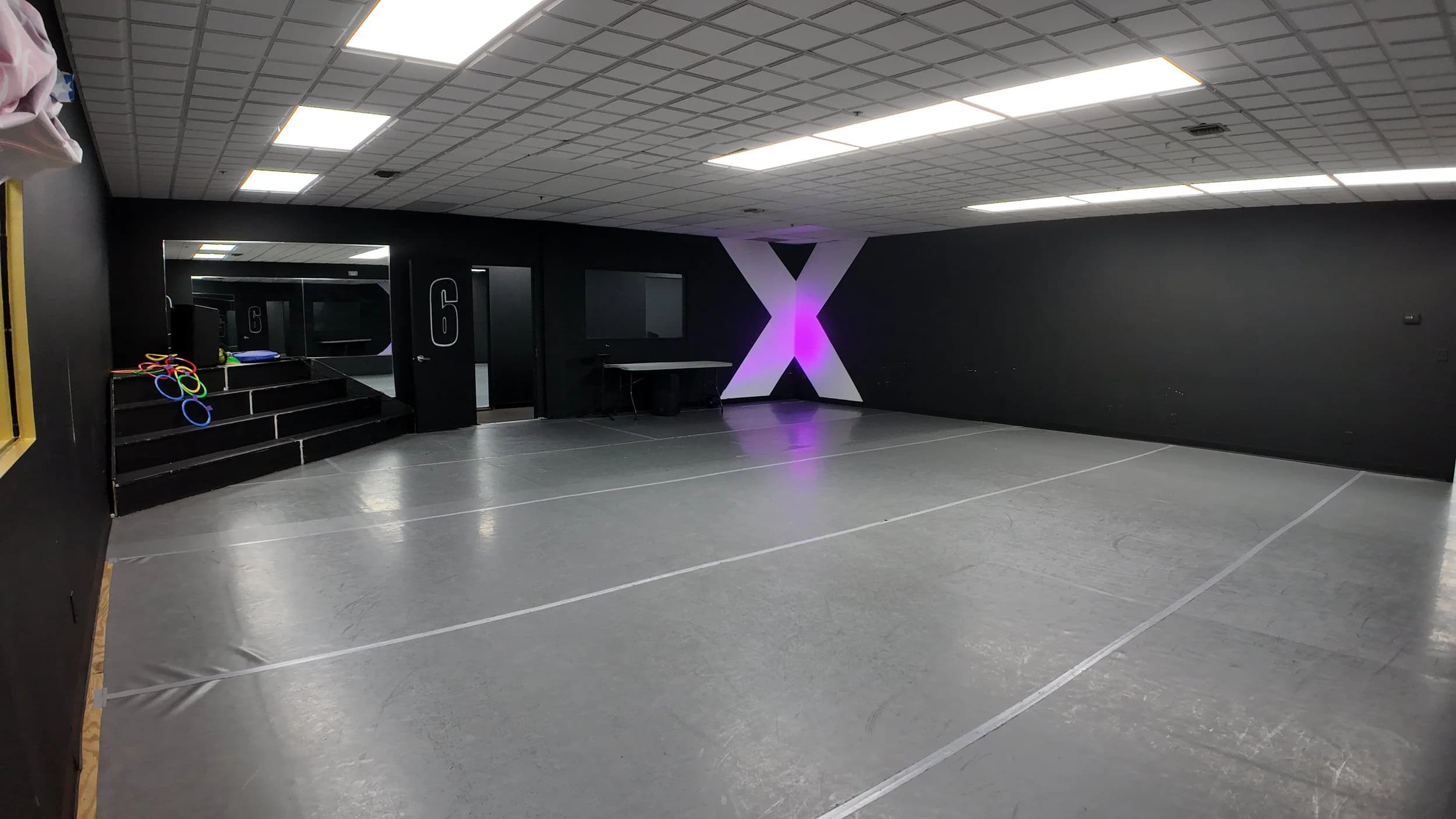 DXNY dance studio with purple lighting and hoops