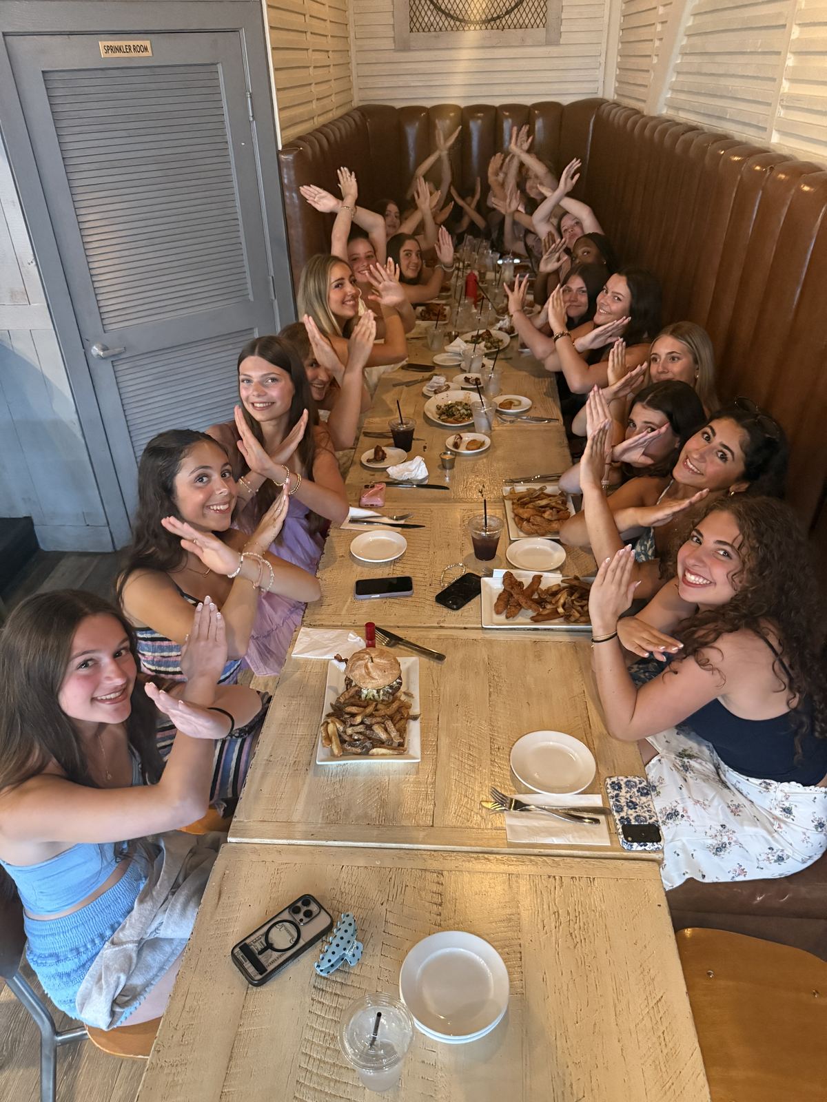 DXNY dancers at a long table for a team dinner in Ocean City